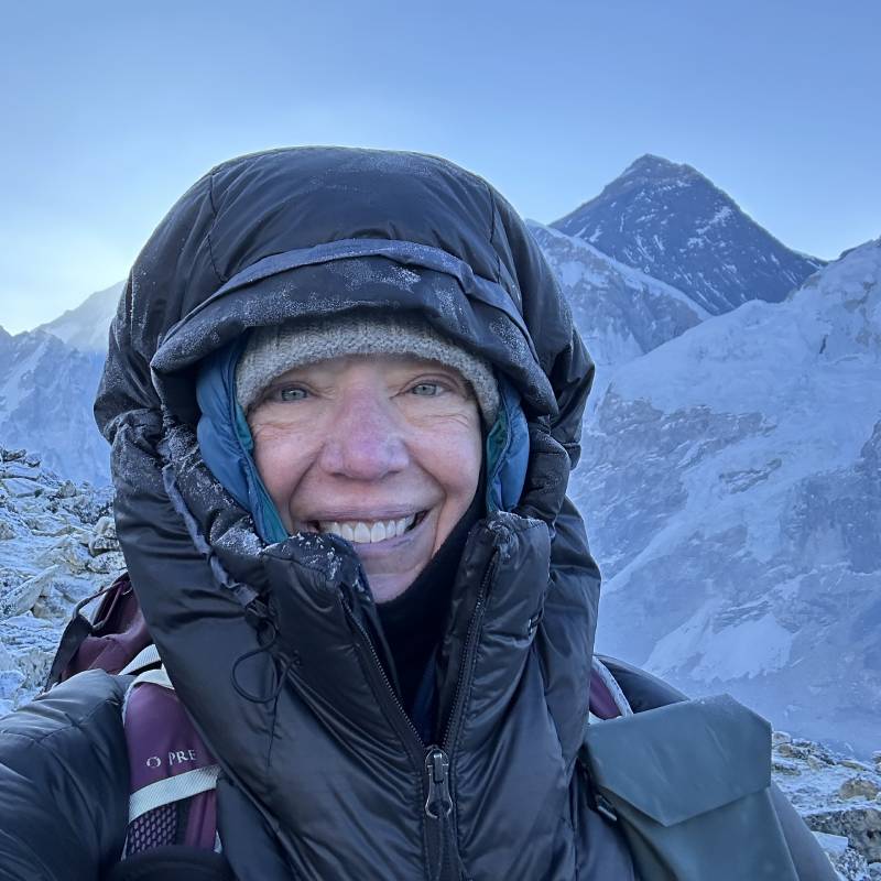 Smiling hiker, snowy mountains