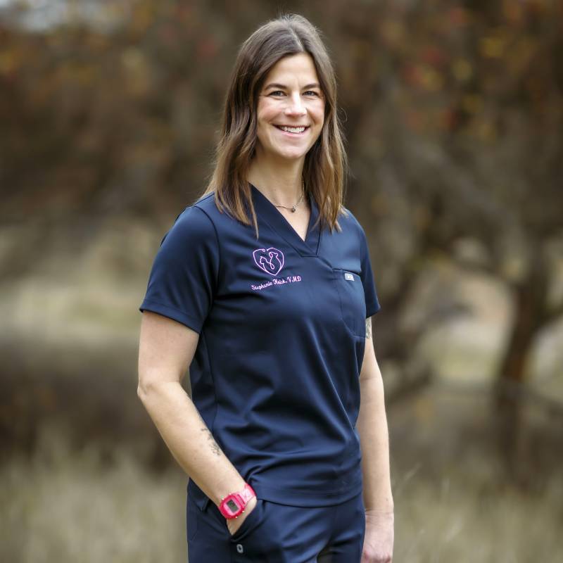 Smiling woman navy scrubs